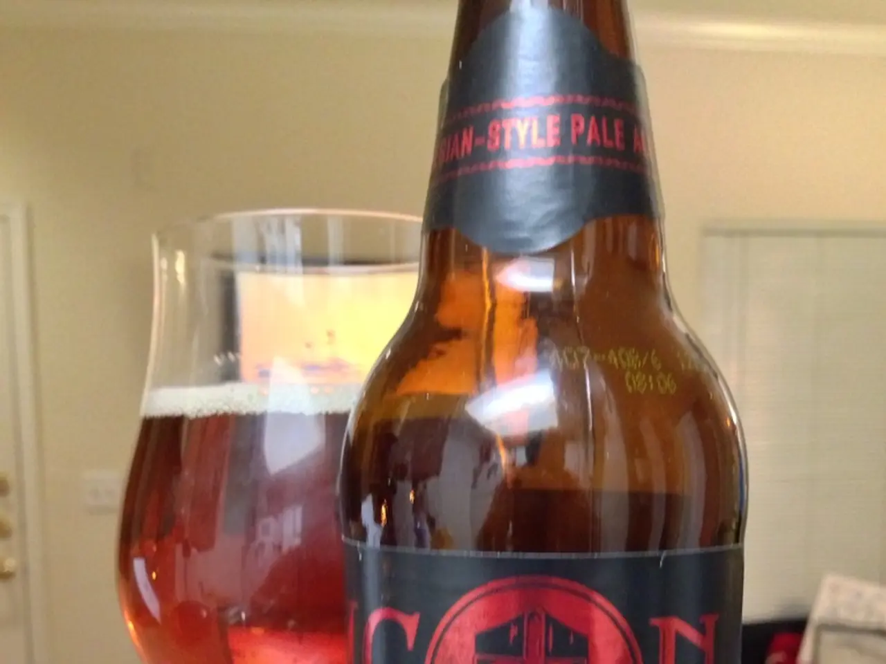 In the image we can see there is a wine bottle and a wine glass and a atm card.