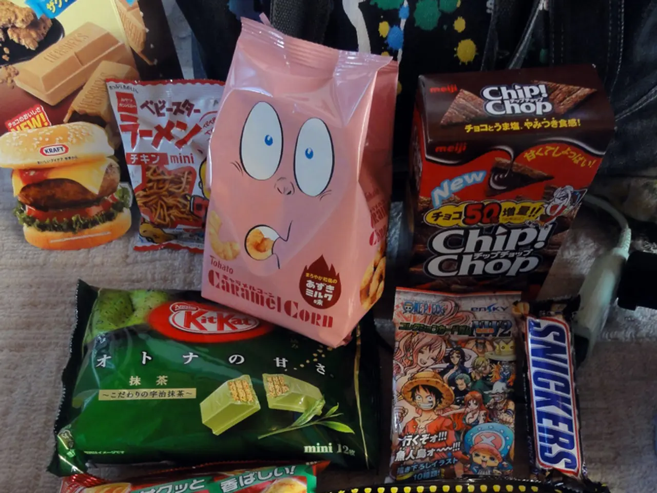 In this image there are some packaged food items with some text on it are placed on the mat.