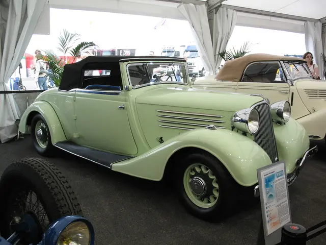 In the image there are few vintage cars on the floor and behind it there are curtains to the...