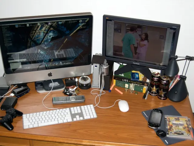 In this image we can see a monitor, keyboard, mouse, remote, keys, mobile phone, tins, table lamp,...