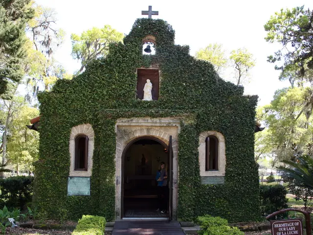 In this picture we can see the sky, a holy church, bell, sculpture. On the top of a church we can...