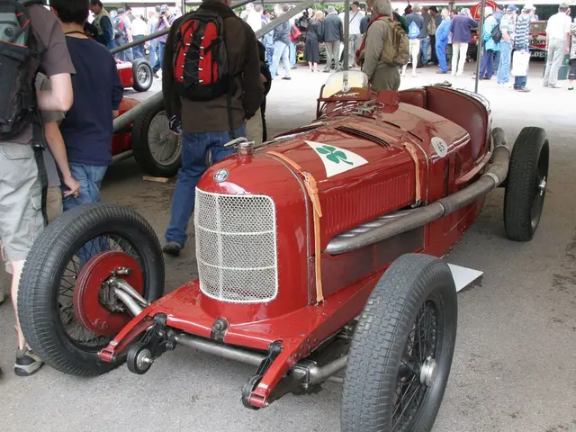 There are some vehicles. Near to that there are many people. Some are wearing bags. On the vehicle...