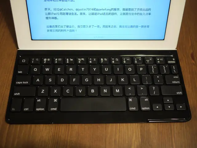 There is a laptop on a wooden surface.