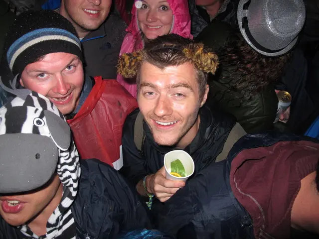 In this image we can see some group of persons wearing sweaters and some are wearing caps standing...