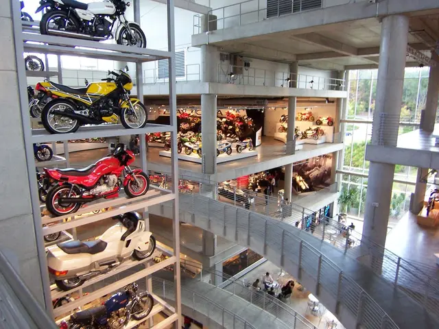 In this image I can see I can see so many bikes displayed inside the building, also there is a view...