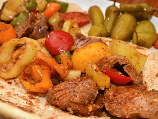 This a food item in it there are tomatoes, chilies, chicken is present in the plate.
